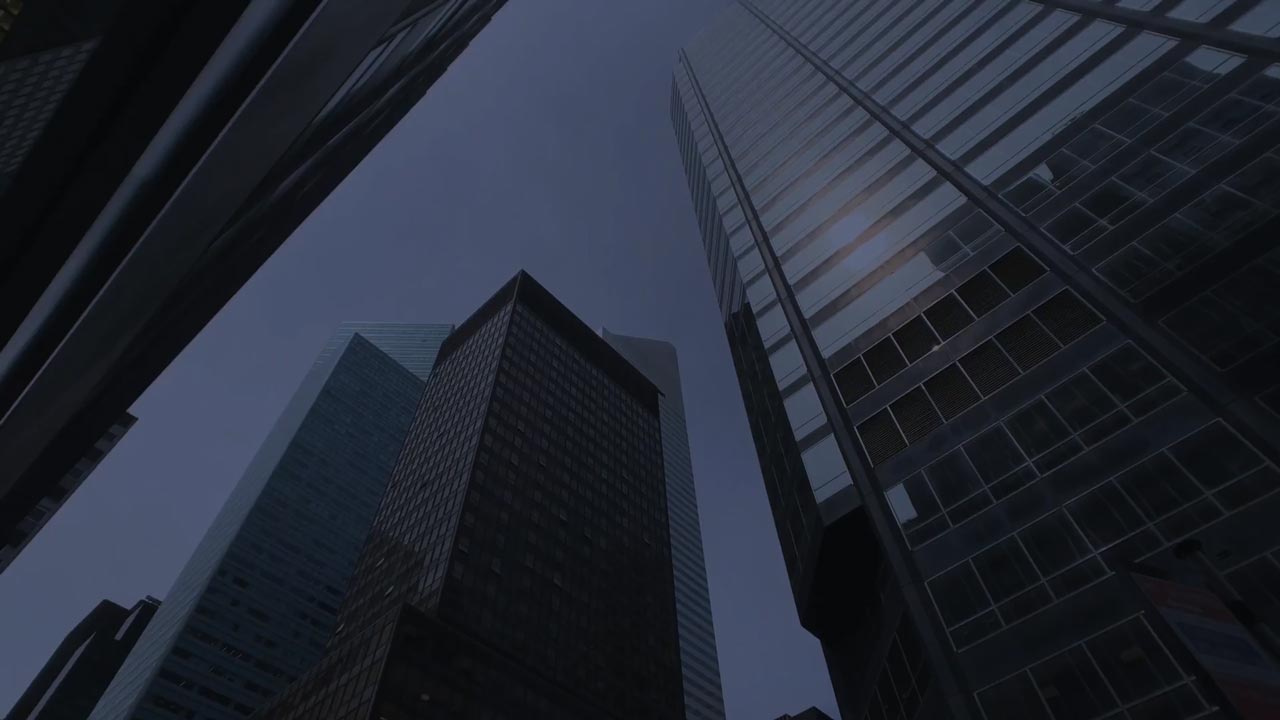 An upward view of towering skyscrapers disappearing into the overcast sky, showcasing the might of urban architecture and hinting at the complex legal landscapes navigated by divorce lawyer Smithtown.