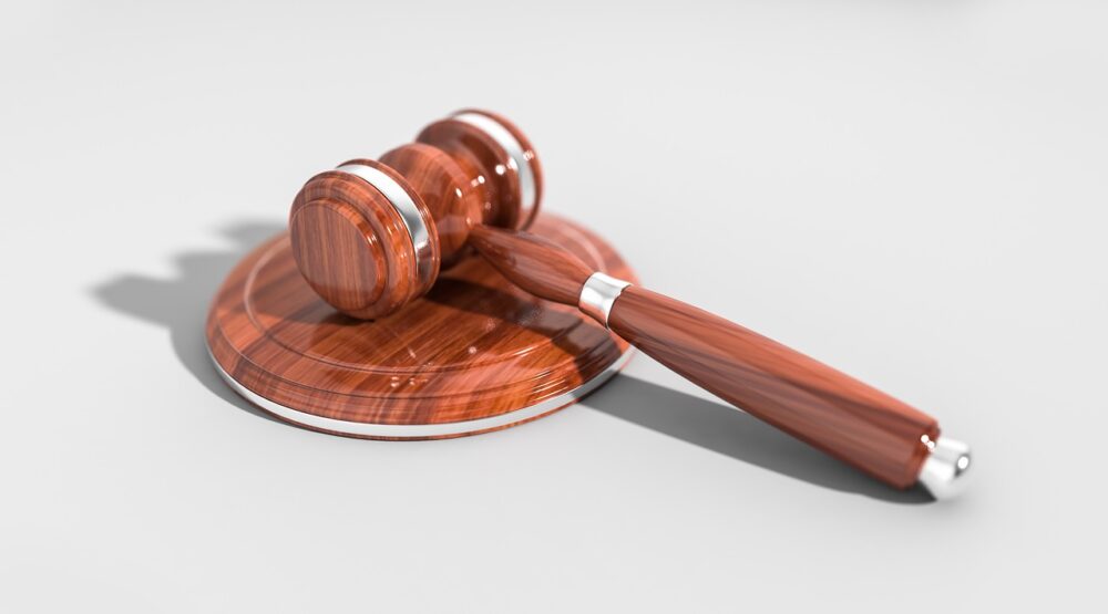A wooden judge's gavel lying on its side on a white background, symbolizing law, justice, and authority in matters like permanent alimony in NY.