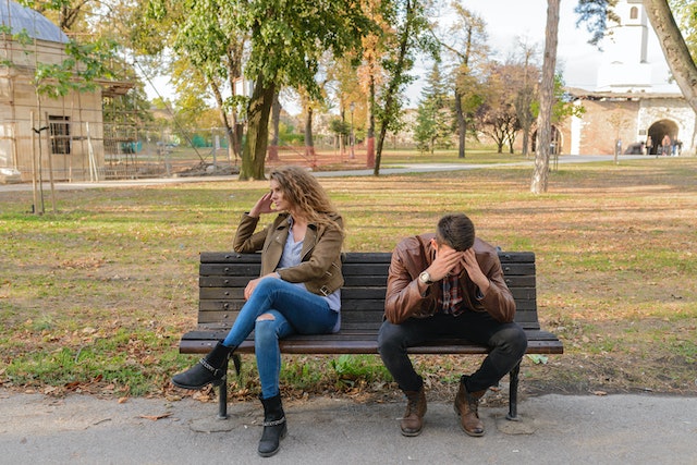 two upset people on a bench