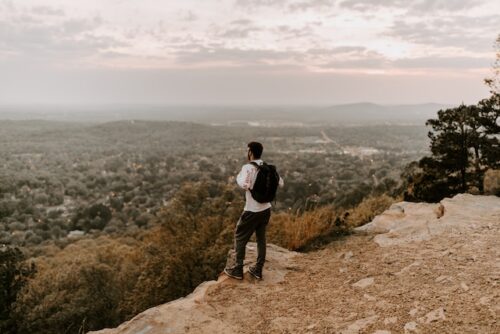 man standing alone on cliff