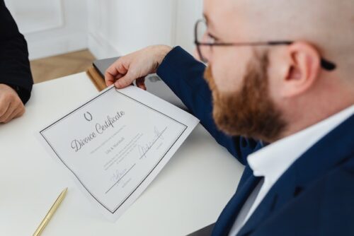man holding divorce certificate