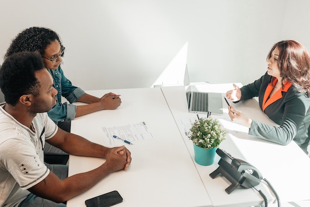 two people at meeting with documents