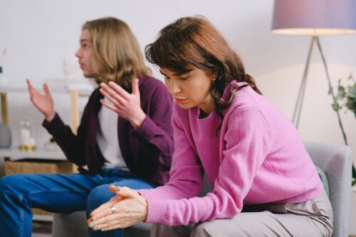 two people on couch arguing