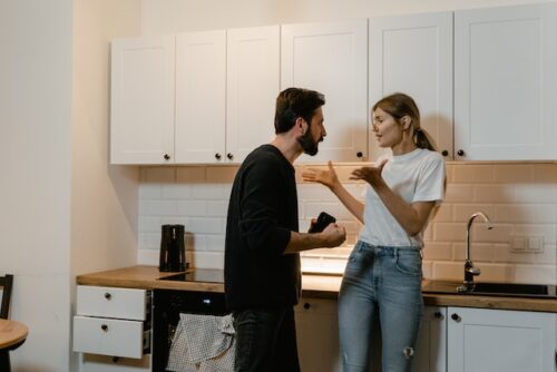 man and woman arguing in kitchen