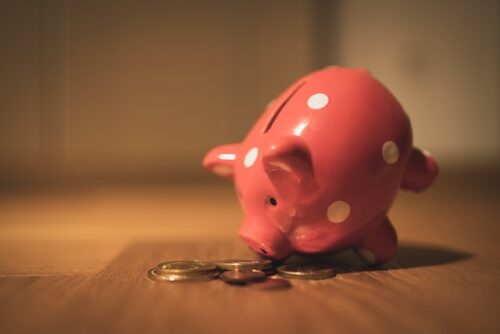 pink piggy bank near coins