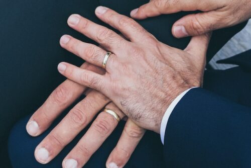 two men with wedding rings